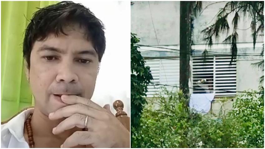 Yunior García sitiado en su propia casa muestra una rosa blanca por la ventana